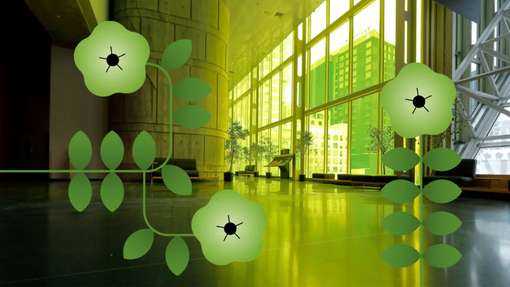 Grandes fleurs vertes stylisées devant la verrière colorée du Palais des congrès, reflétées sur le sol